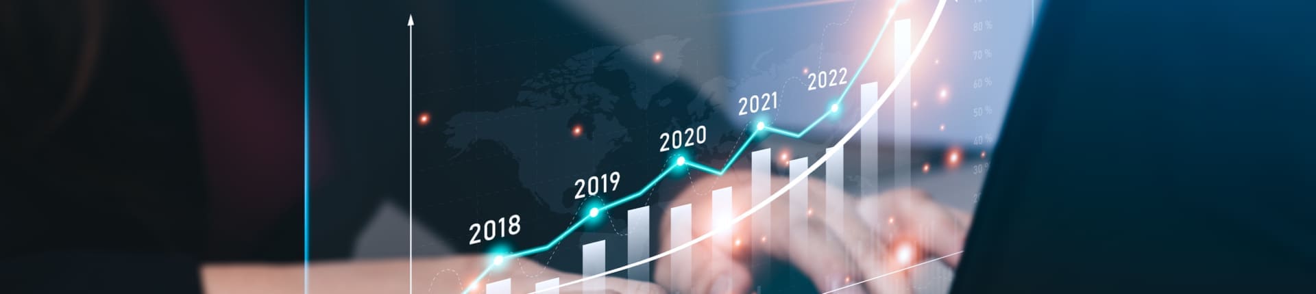 Businessman planning 2023 business growth on desk with virtual hologram chart graph. businessman calculates financial data for long-term investments and goals for success in the year 2023