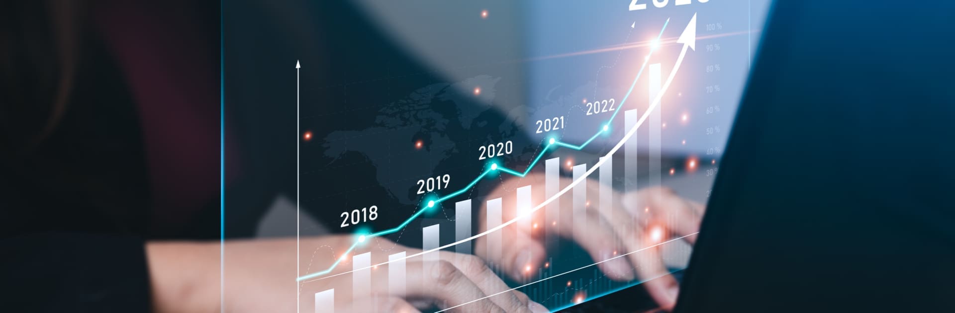 Businessman planning 2023 business growth on desk with virtual hologram chart graph. businessman calculates financial data for long-term investments and goals for success in the year 2023